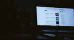Computer monitor glowing in a dark office during a power outage